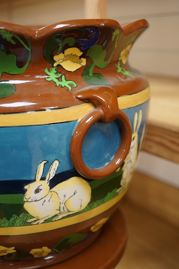 A large Foley Intarsio jardiniere on stand, designed by Frederick Rhead, decorated with rabbits, 60cm high. Condition - restored